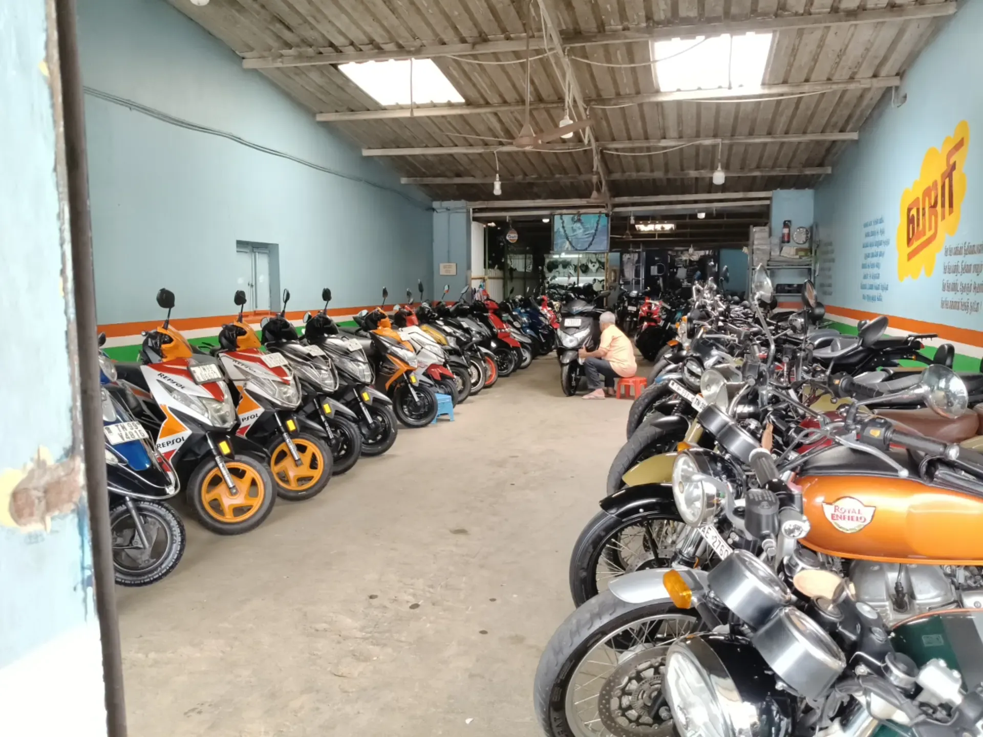 Bikes lined along the painted showroom wall
