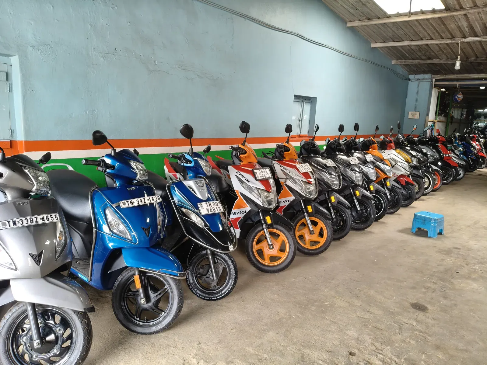 Row of used scooters along the showroom wall